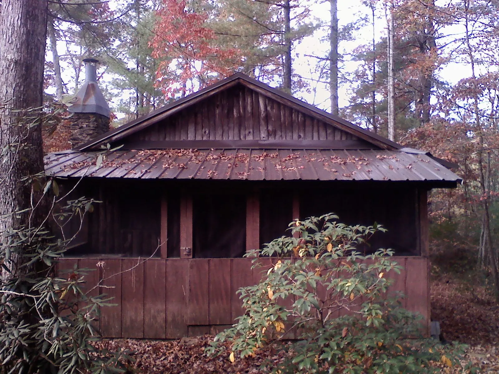 Metal roof over the screened porch of a rustic cabin in Stewartstown
