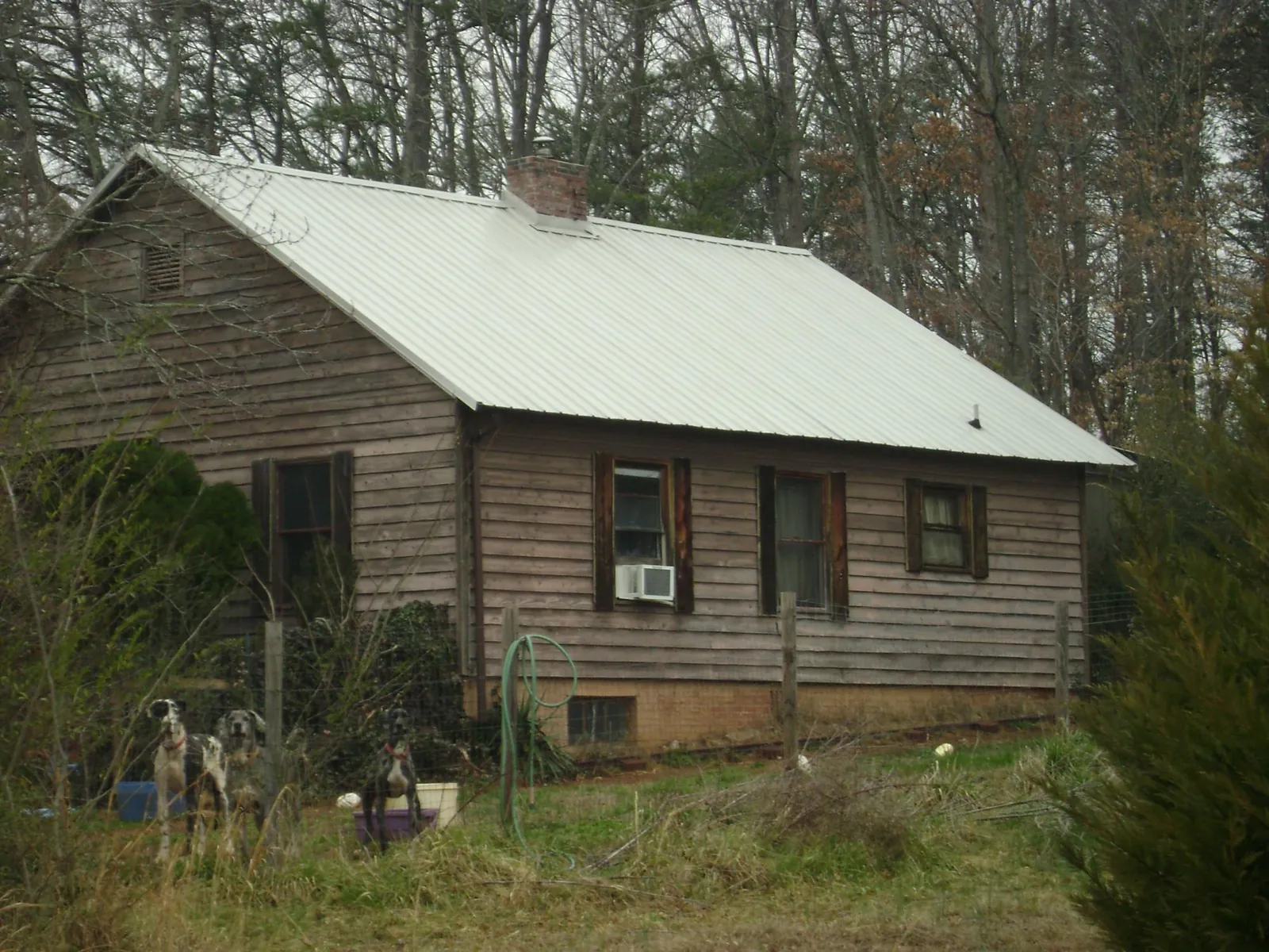 White metal roof on an old wood sided farmhouse, from a Metal Roof Installation job in Stewartstown